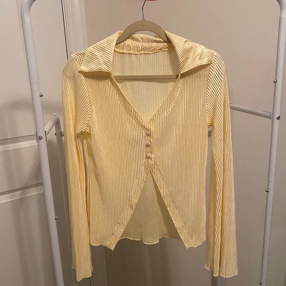 Yellow blouse with middle button closure, never worn.